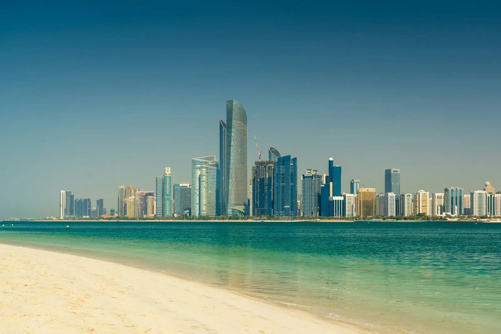 The Abu Dhabi skyline across the water from the beach, the alternative to the DIFC