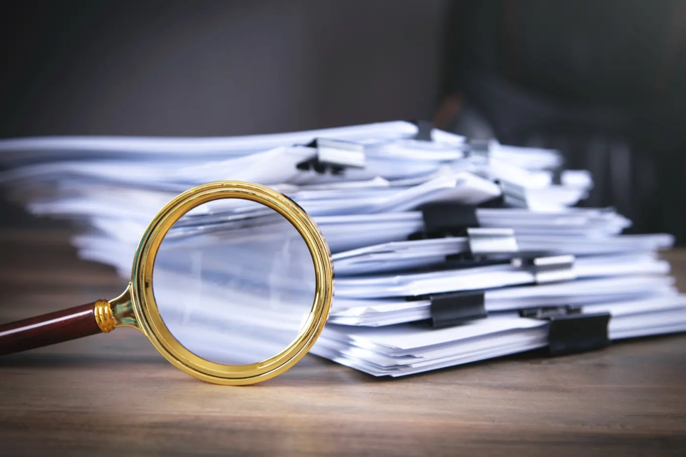A magnifying glass over a stack of filings, the closer look nominee and ownership records now attract