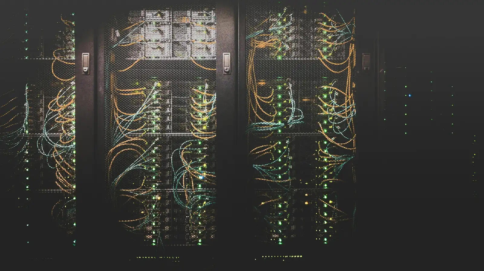 A data centre with rows of servers and cabling, the infrastructure behind the AI systems DIFC Regulation 10 governs