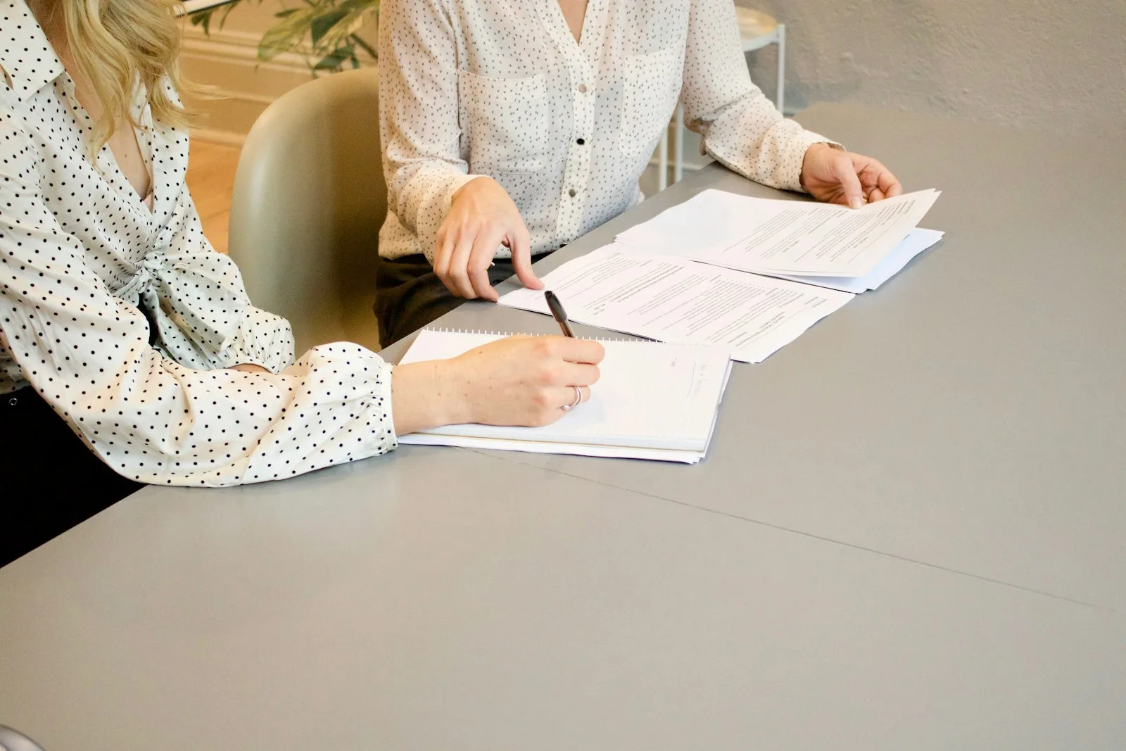 Documents reviewed and signed at a desk, the paperwork a Dubai setup turns on