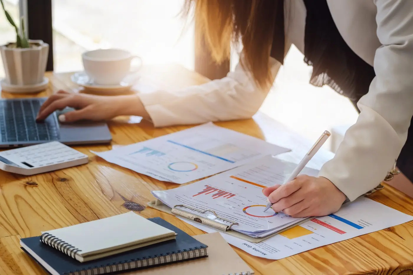 An adviser working through financial analysis at a desk, part of the professional ecosystem the DIFC offers