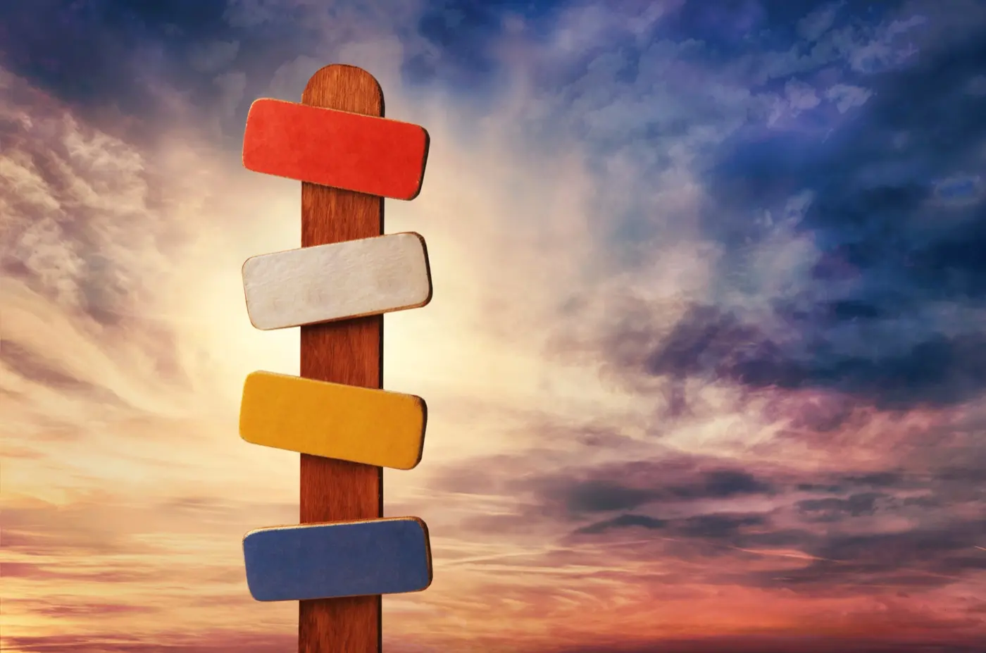 A blank signpost pointing several ways against an evening sky, the choice of where a structure belongs