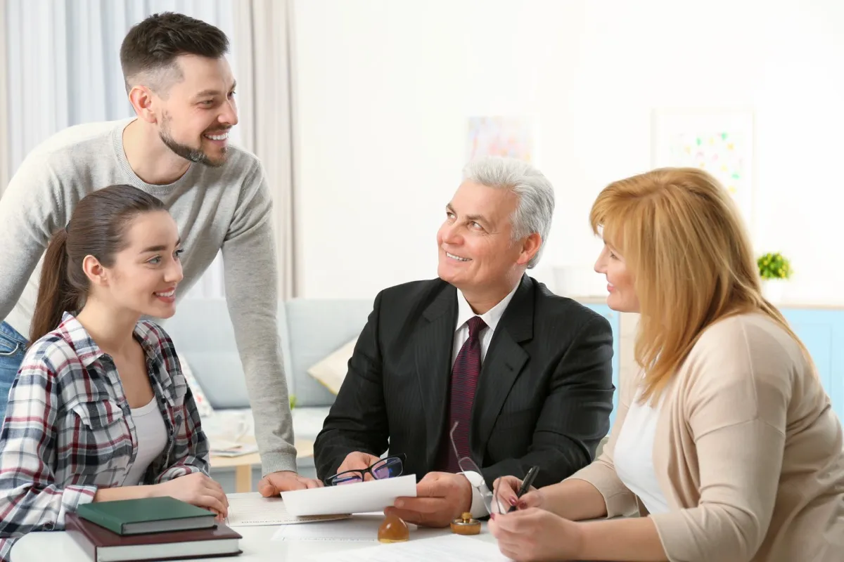 A family meeting their adviser across a table, the conversation that has to happen before it is needed