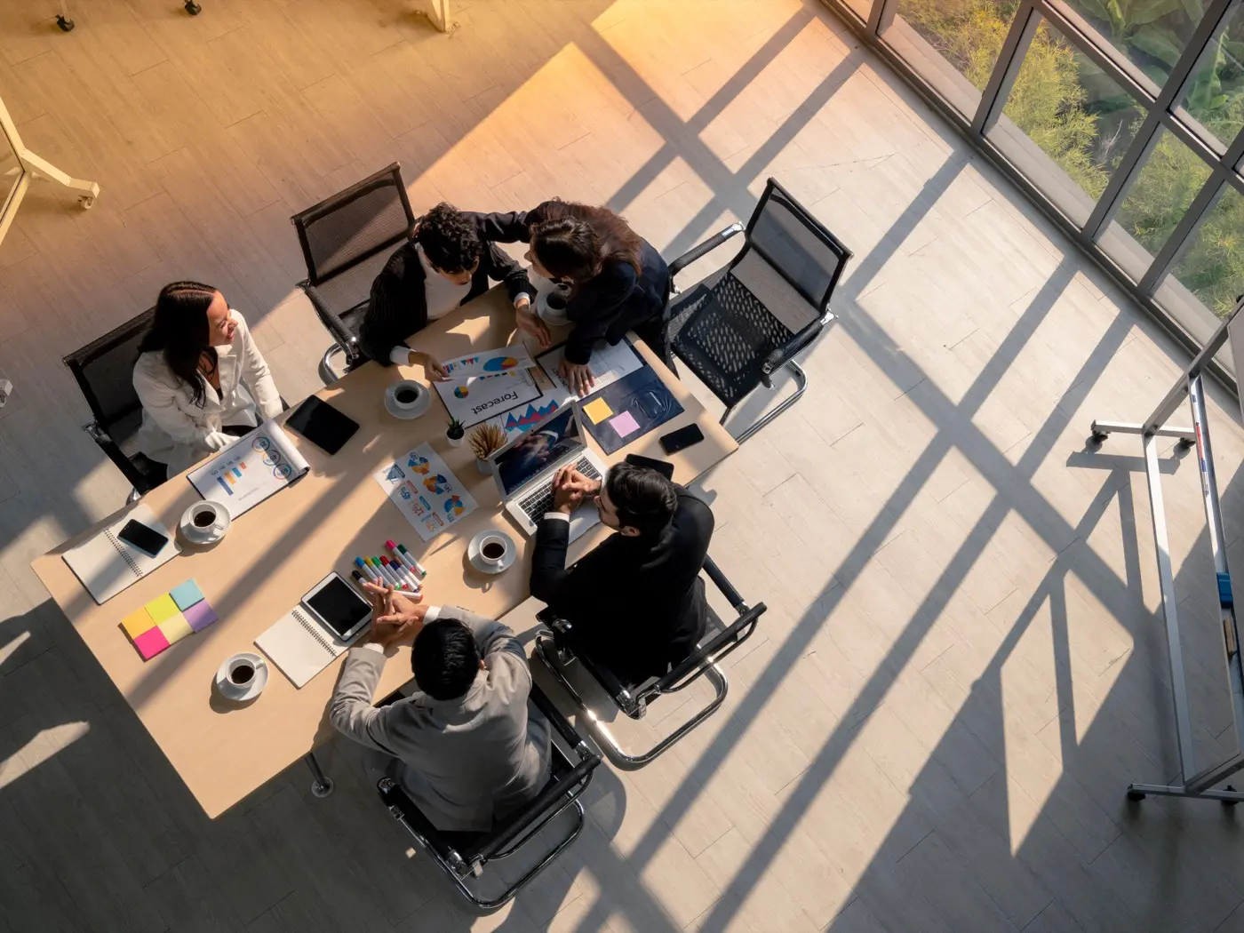 A meeting room seen from above, where advisers work through a family foundation's tax position