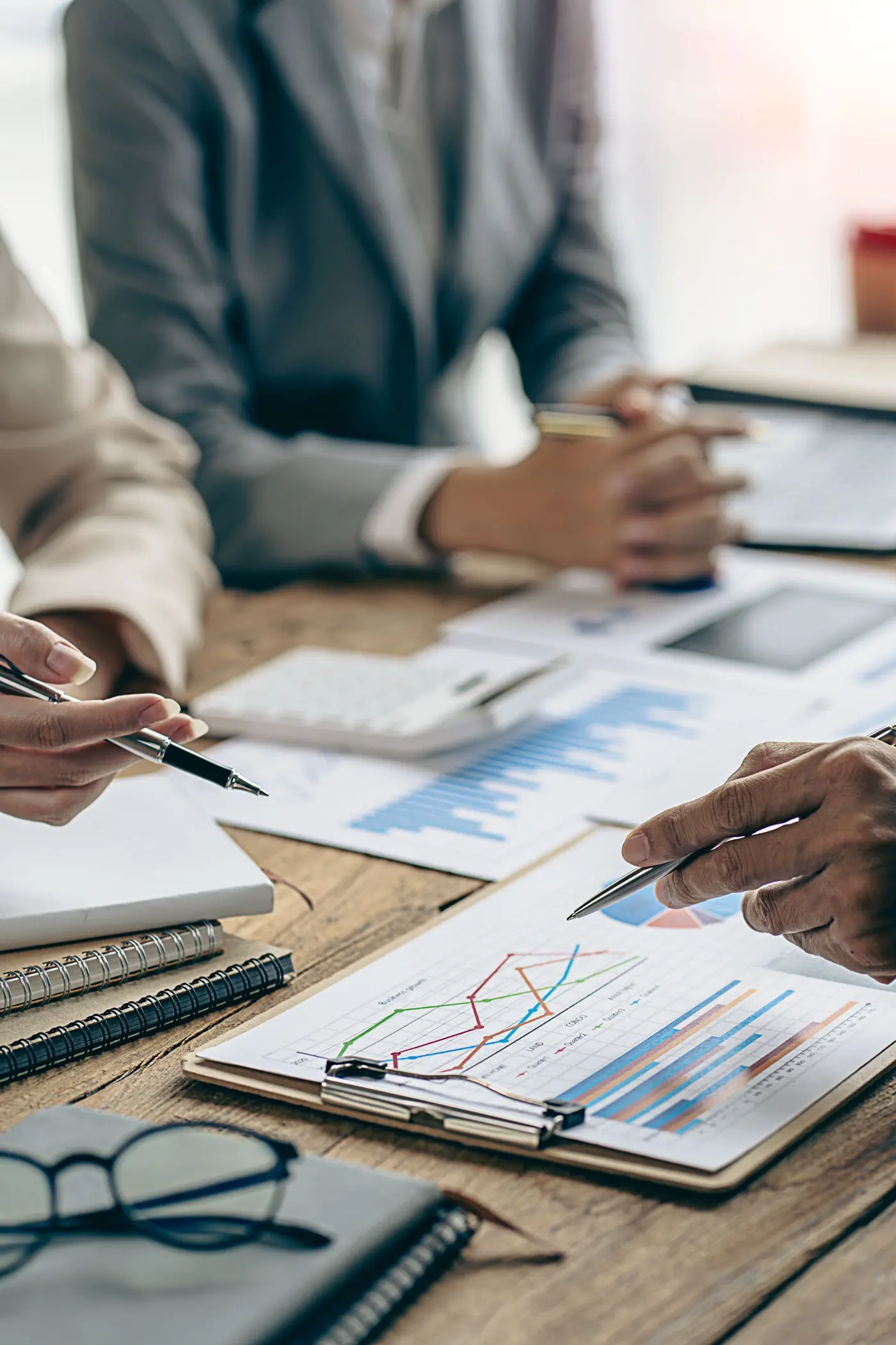 Charts and working papers across a desk, the material a bank reviews before opening a family office account