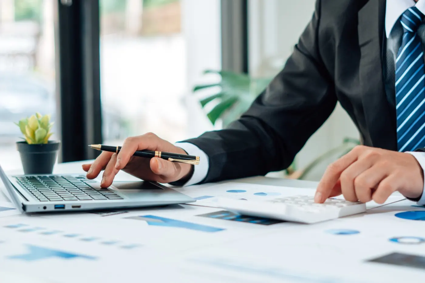 Figures checked against a laptop and calculator, the review a holding company's tax position needs