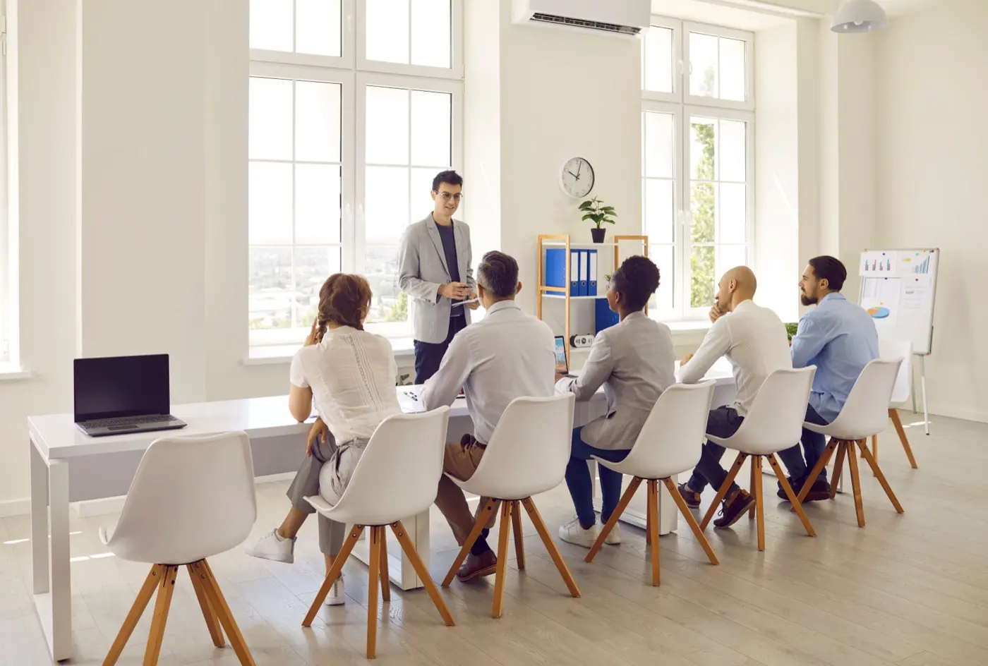 A board meeting in a bright office, where a resident director is expected to actually turn up