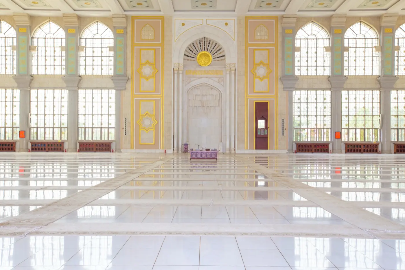 A mosque interior with light through tall arches, the tradition a Sharia-conscious structure is built around