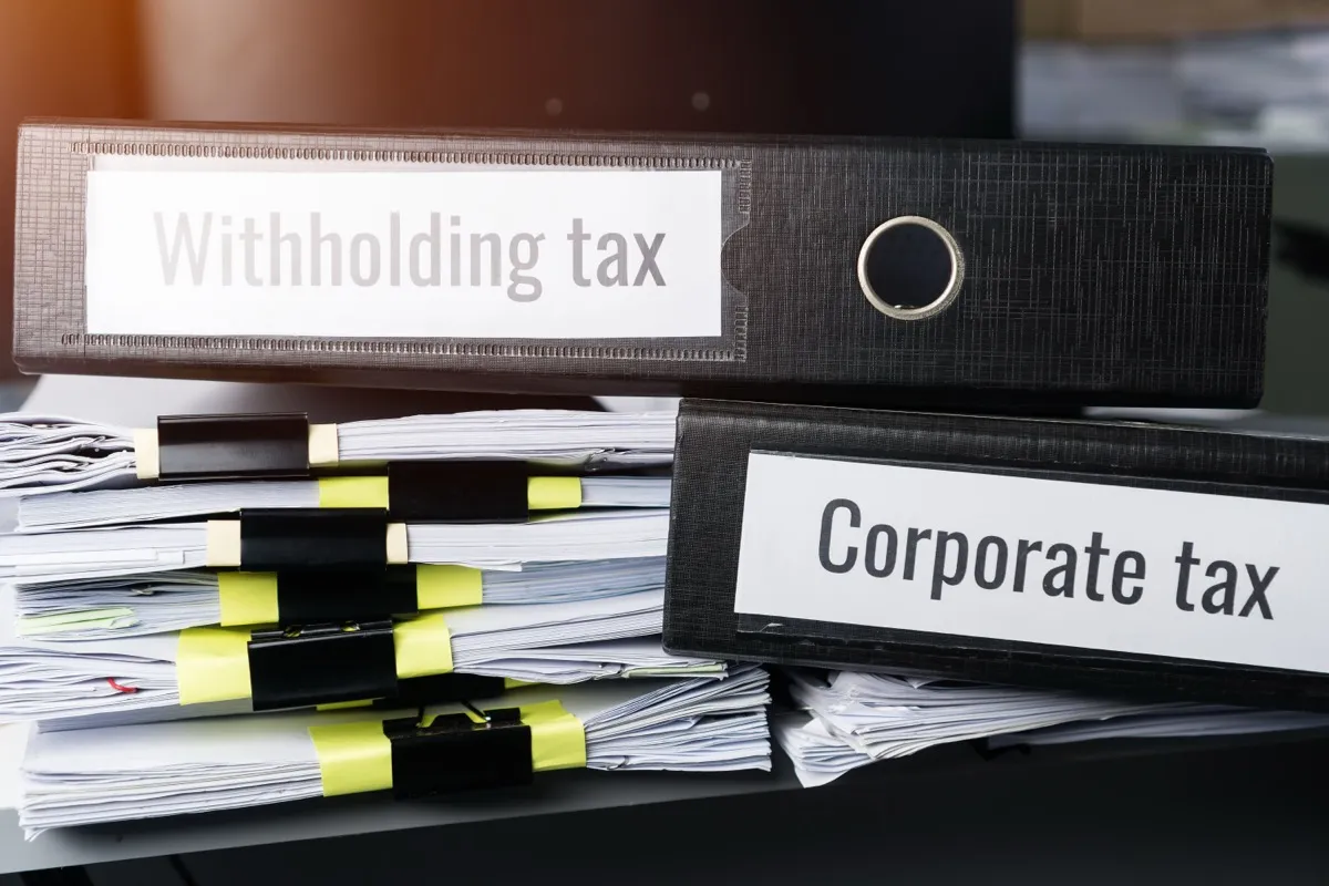Files labelled for corporate and withholding tax, the records a first corporate tax return draws on